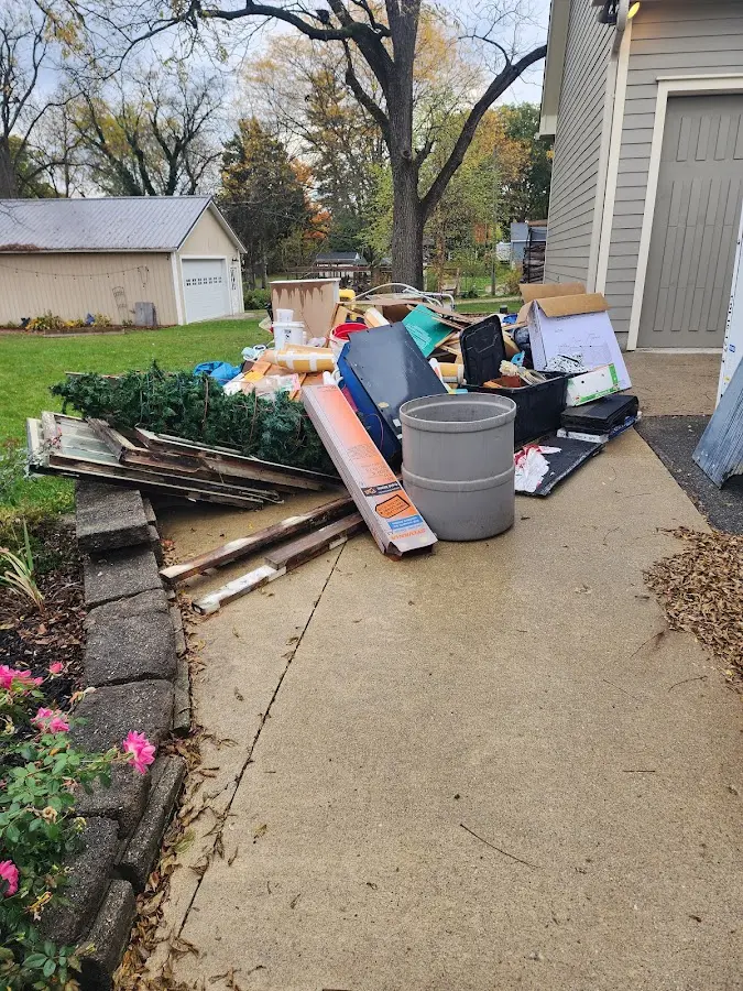 Dumpster being loaded with debris for Roofing Dumpster Rental in Kronenwetter